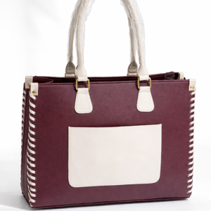 Maroon and cream women's tote handbag with dual handles and front pocket on white background.